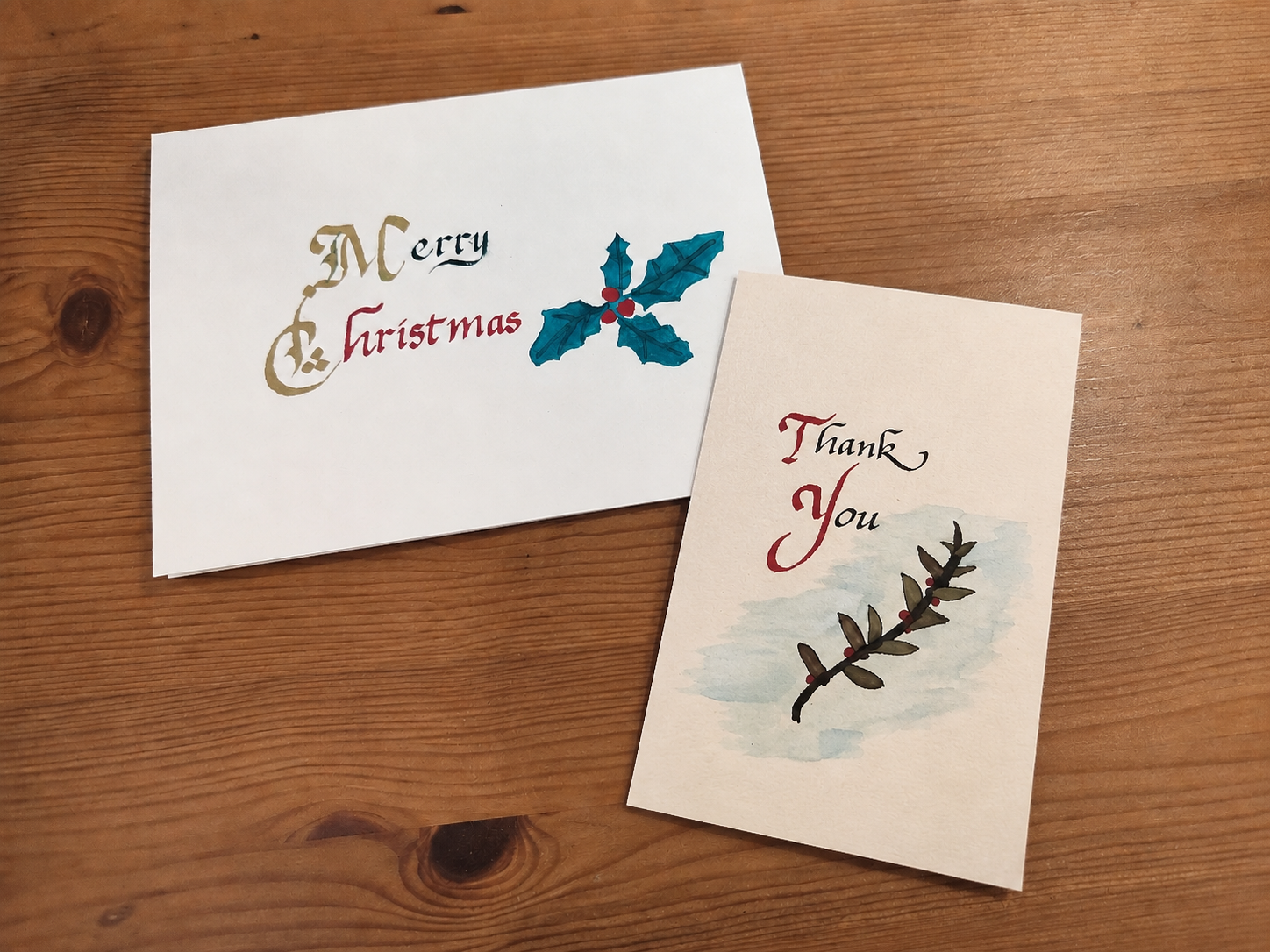 Hand-painted Christmas and thank-you cards with calligraphy and botanical details